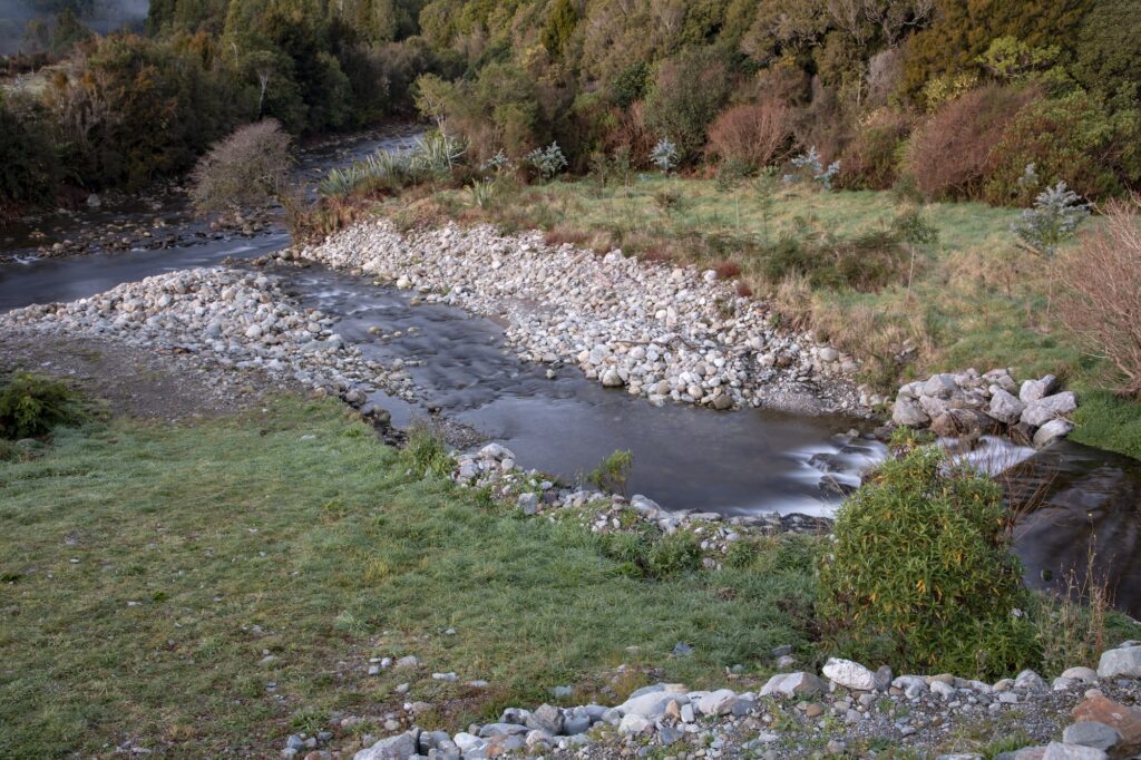 A river running through a grassy area.